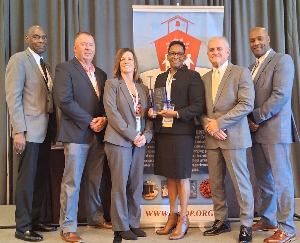 Dr. Carolyn Gentle-Genitty holding the 2026 IATDP Person of the Year award with IATDP leaders at the 114th Annual Conference in Corpus Christi