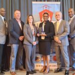 Dr. Carolyn Gentle-Genitty holding the 2026 IATDP Person of the Year award with IATDP leaders at the 114th Annual Conference in Corpus Christi